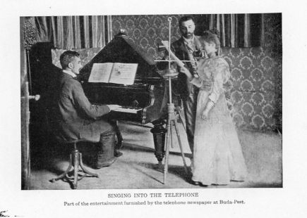 SINGING INTO THE TELEPHONE
Part of the entertainment furnished by the telephone newspaper at Buda-Pest.